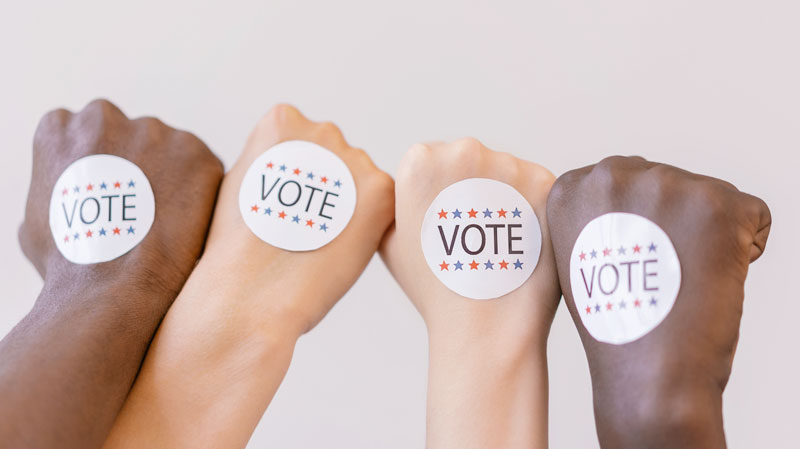 hands with vote stickers