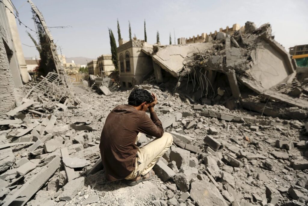 A guard sits on the rubble of the house of Brigadier Fouad al-Emad, an army commander loyal to the Houthis, after US air strikes destroyed it in Sanaa, Yemen on June 15, 2015.Khaled Abdullah / Reuters