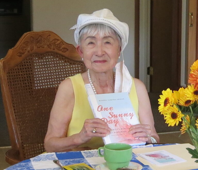 Photo of Hideko Tamura Snider showing her book One Sunny Day